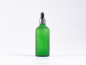 Preview: Grünglasflasche 100ml, mit Pipette silber-glanz